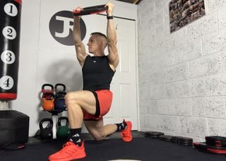 Les Mills trainer Justin Riley demonstrating a kneeling wood chop to split lunge lift