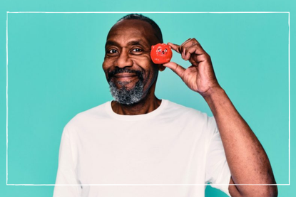 Lenny Henry with a red nose posing for Red Nose Day 2022