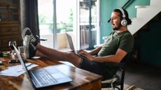 Man with feet up on desk using a laptop