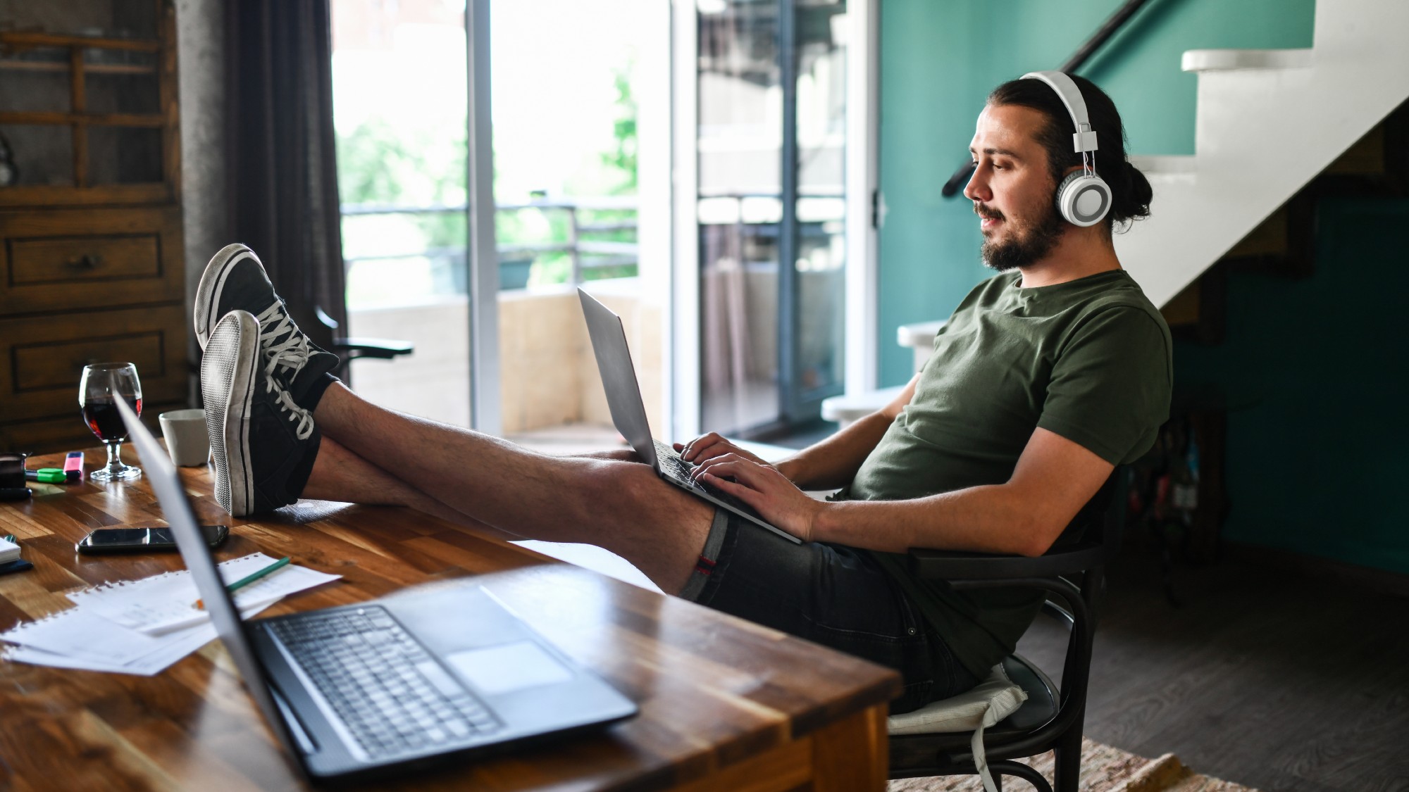 Man with feet up on desk using a laptop
