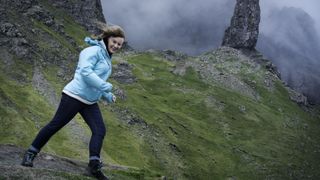 A hiker on Skye leans into the strong wind
