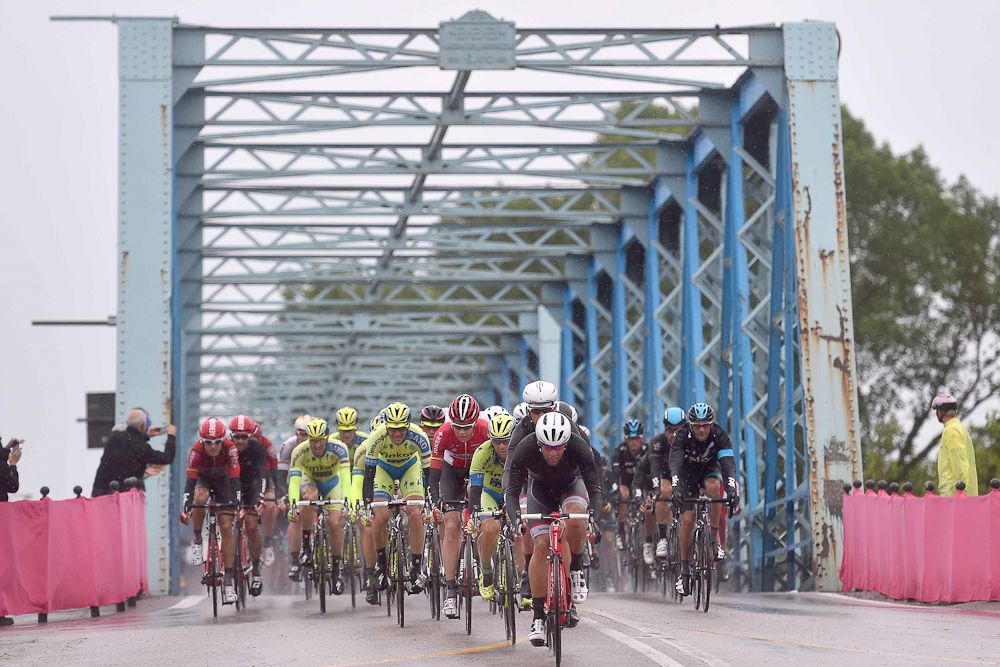 The peloton goes over a bridge durng stage 13.