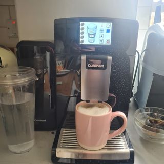 Cuisinart Veloce coffee machine with a pink mug full of coffee on kitchen counter