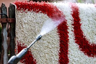 Cleaning a carpet with a pressure washer