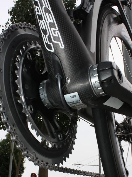 The internally routed rear derailleur housing pops out of the frame just ahead of the bottom bracket.