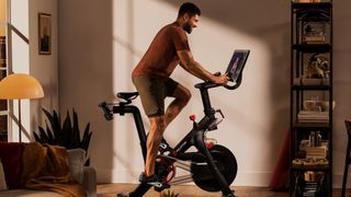 How much is a Peloton bike? image shows man cycling on Peloton bike