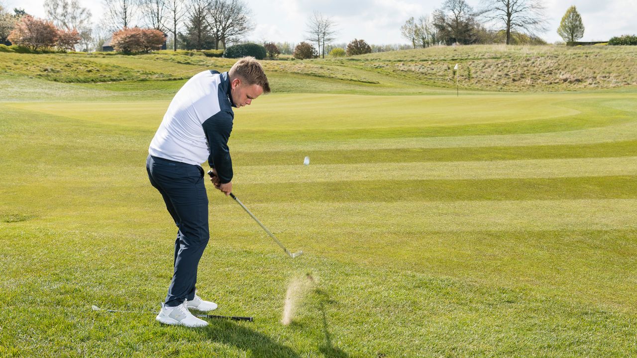 PGA pro Liam James hitting a pitch shot at the London Club