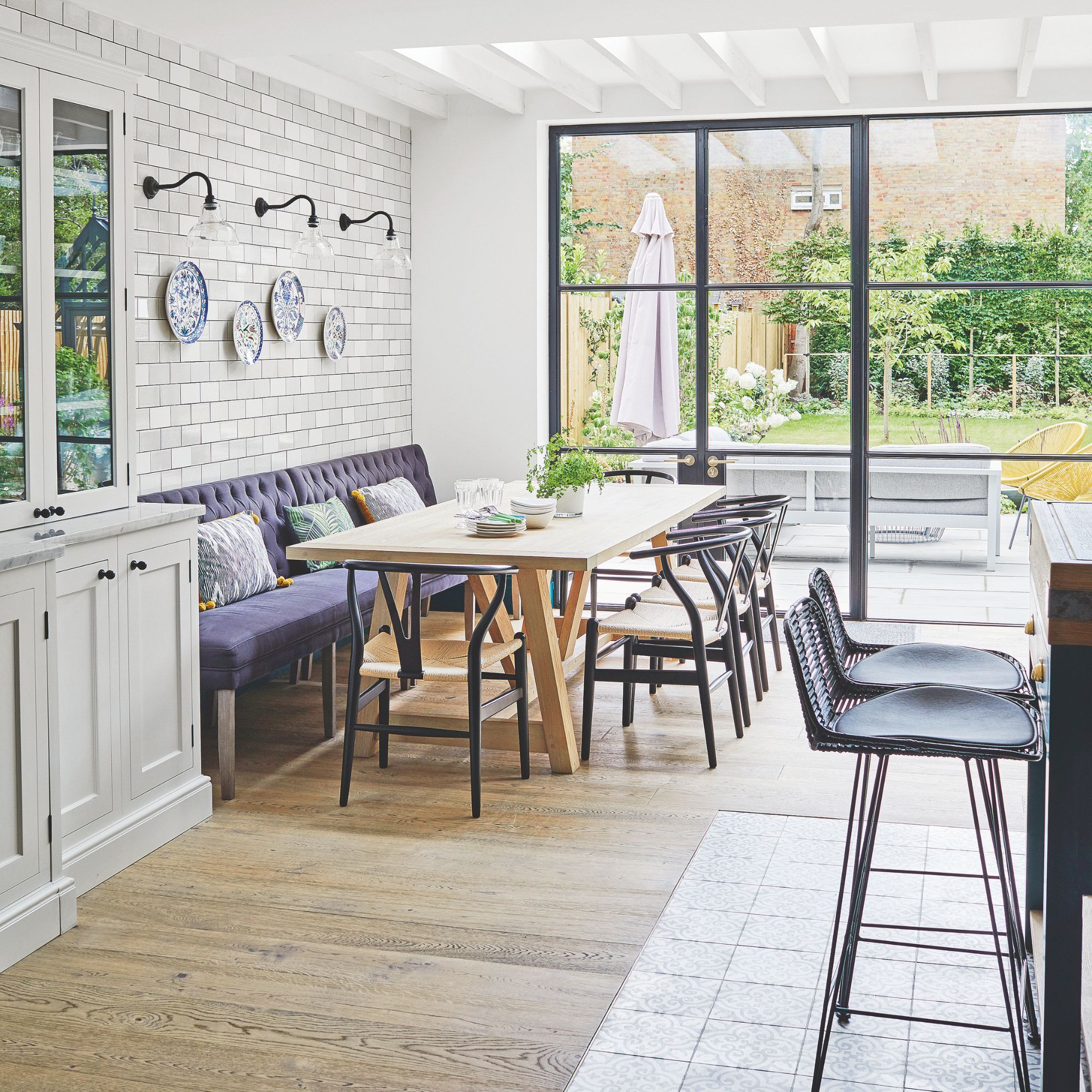 Open plan kitchen-diner with a dining table and bench seating, and wooden floors