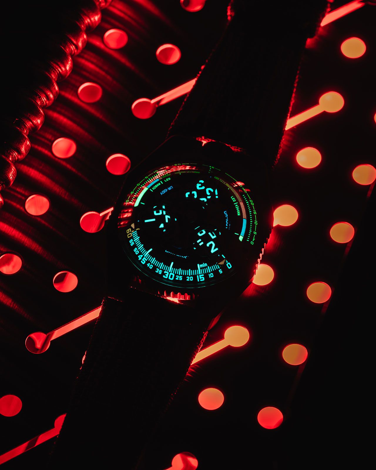 Apertures on either side of the Urwerk's UR-100V P.02 wristwatch use colors to approximate the location of the space shuttle during a typical launch and landing.