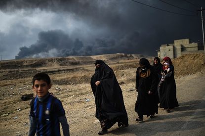 Mosul residents flee from the city on Monday.
