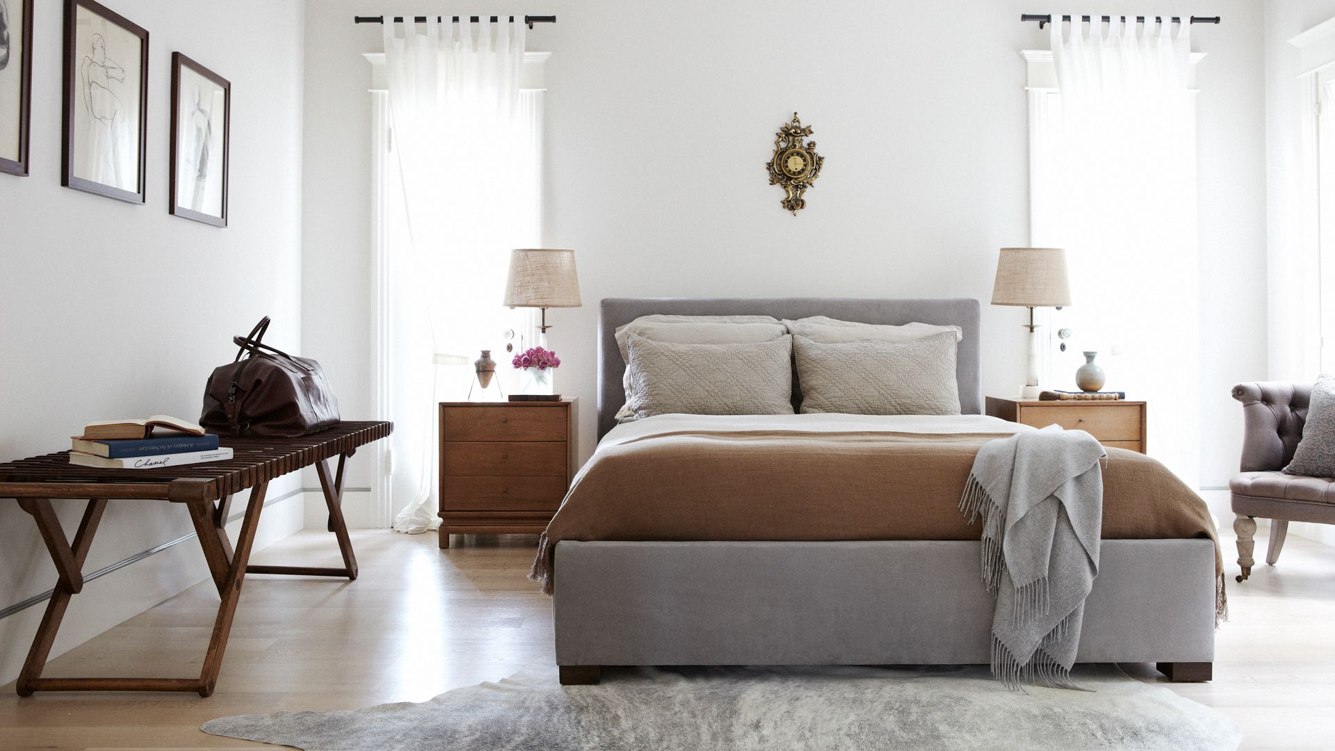 White contemporary bedroom with bed placed centrally to demonstrate how to arrange your bedroom using Feng Shui