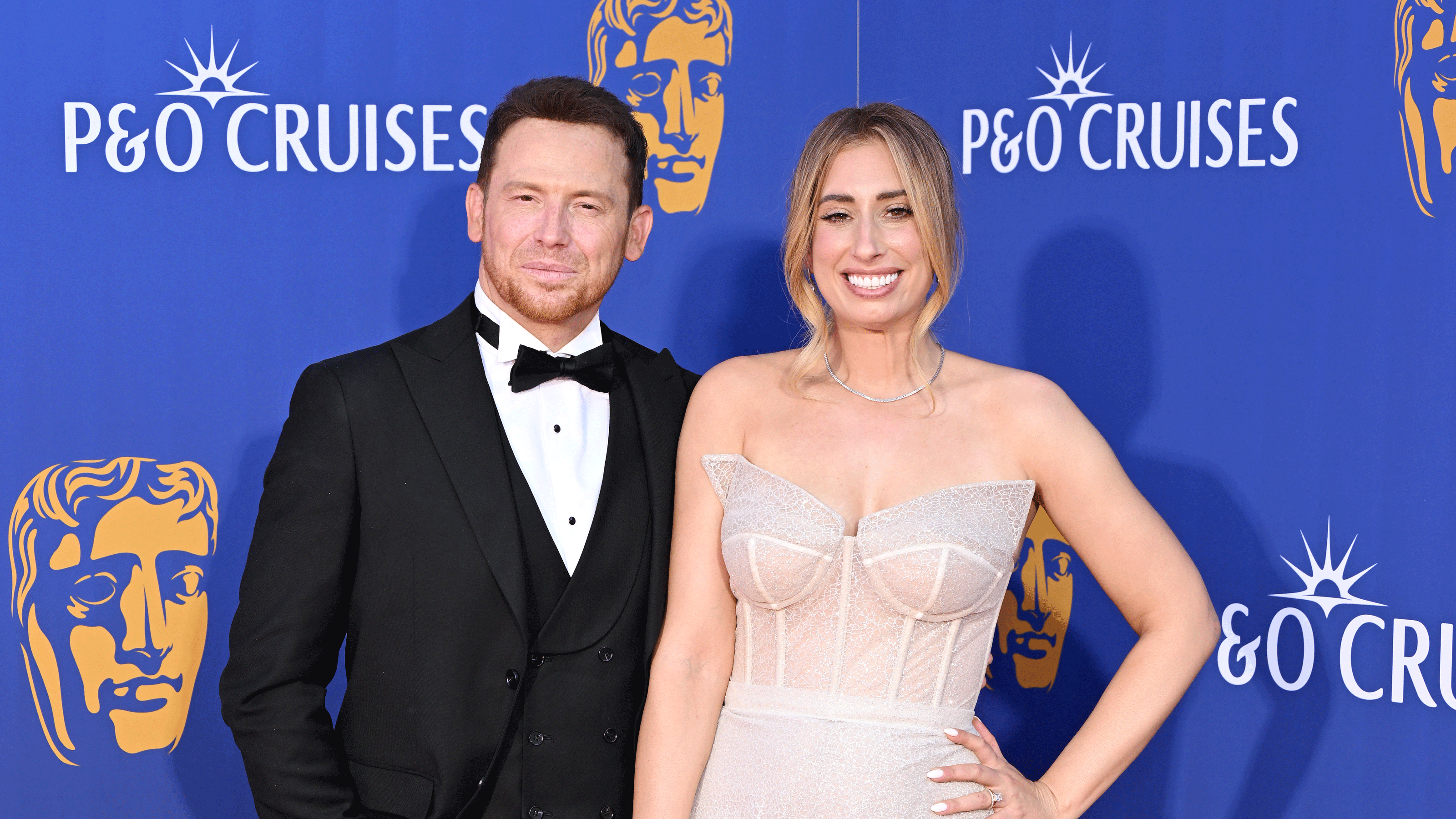 Stacey Solomon and Joe with a blue backdrop