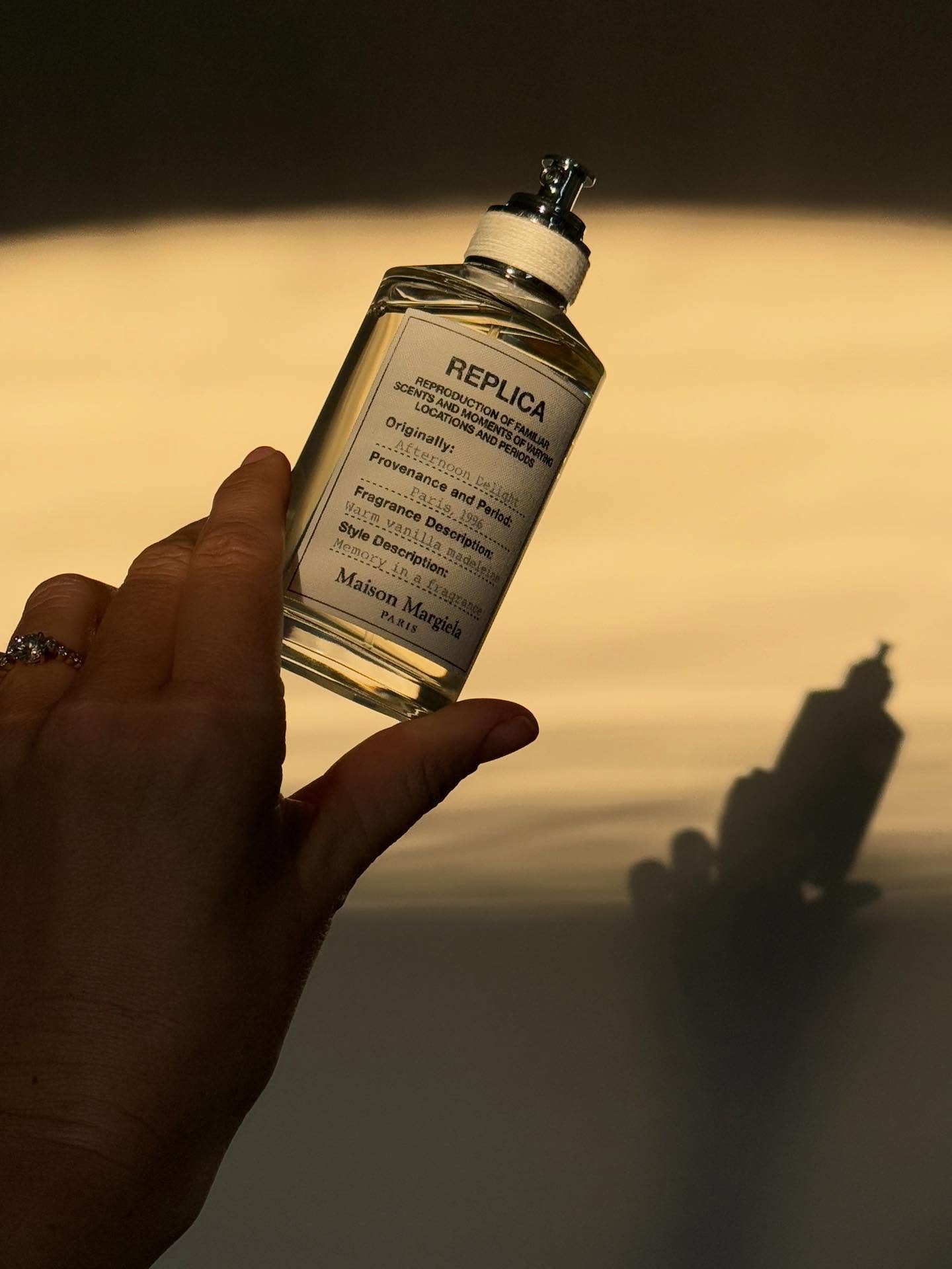 Emma Horeau holding Maison Margiela's Replica Afternoon Delight Eau de Toilette.
