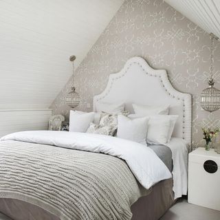 Neutral bedroom with white pillows and modern wall paper