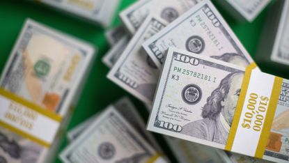 Close up of US $100 bill bundles from high angle of view