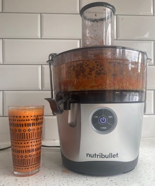 Orange, apple and carrot juice made in a Nutribullet Pro Juicer in white kitchen