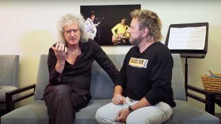 Brian May on a sofa speaking with Sammy Hagar