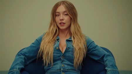 Sydney Sweeney in a denim long-sleeved top and denim wide-legged jeans in an ad for American Eagle.