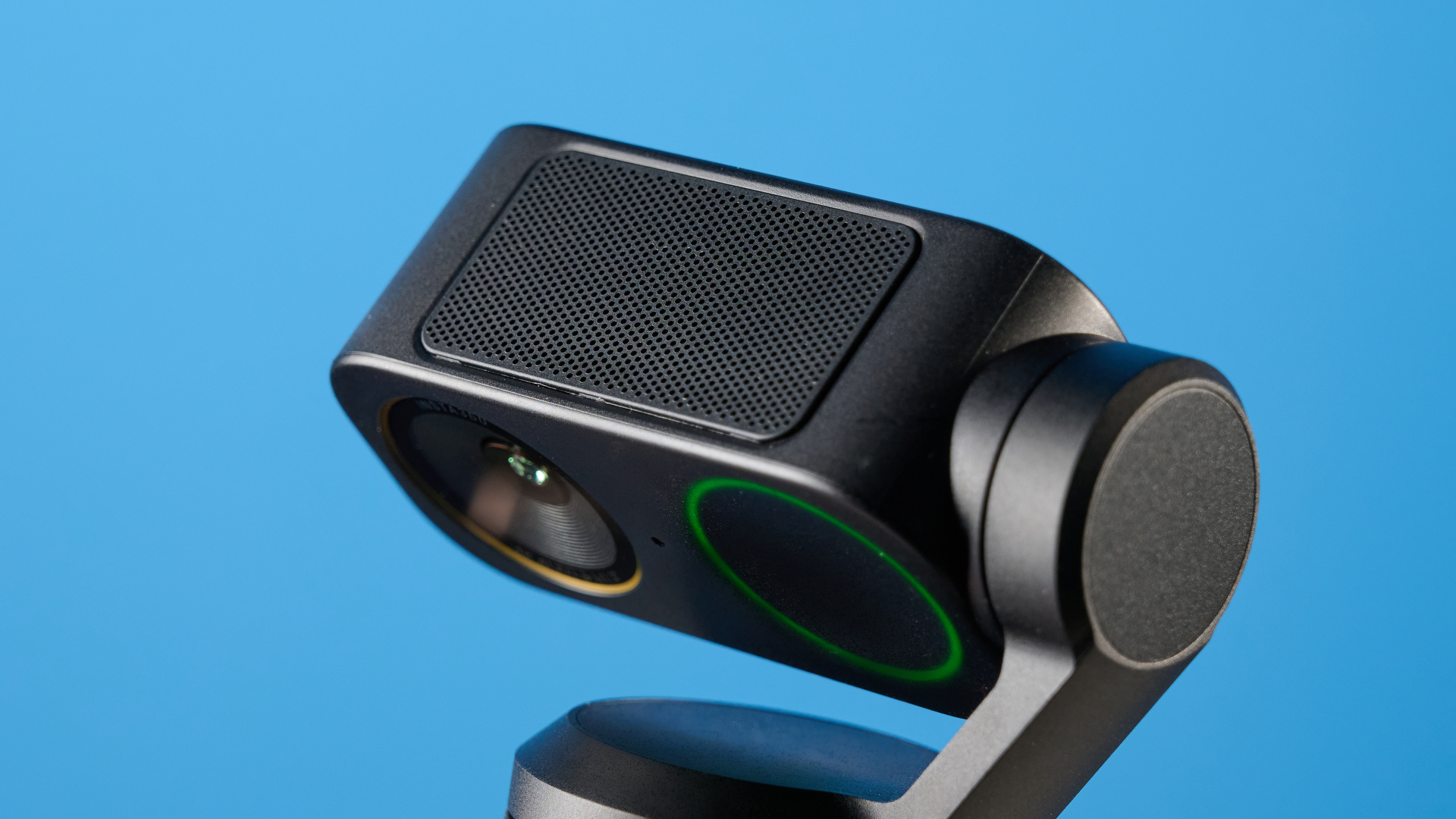 Insta360 Link 2 Pro in graphite black attached to a computer screen photographed on a blue background