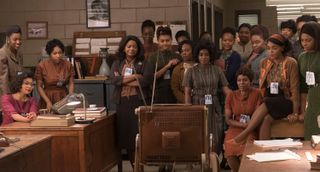Many women, including Taraji P. Henson as Katherine Johnson, Octavia Spencer as Dorothy Vaughan and Janelle Monae as Mary Jackson, watching a TV, in Hidden Figures