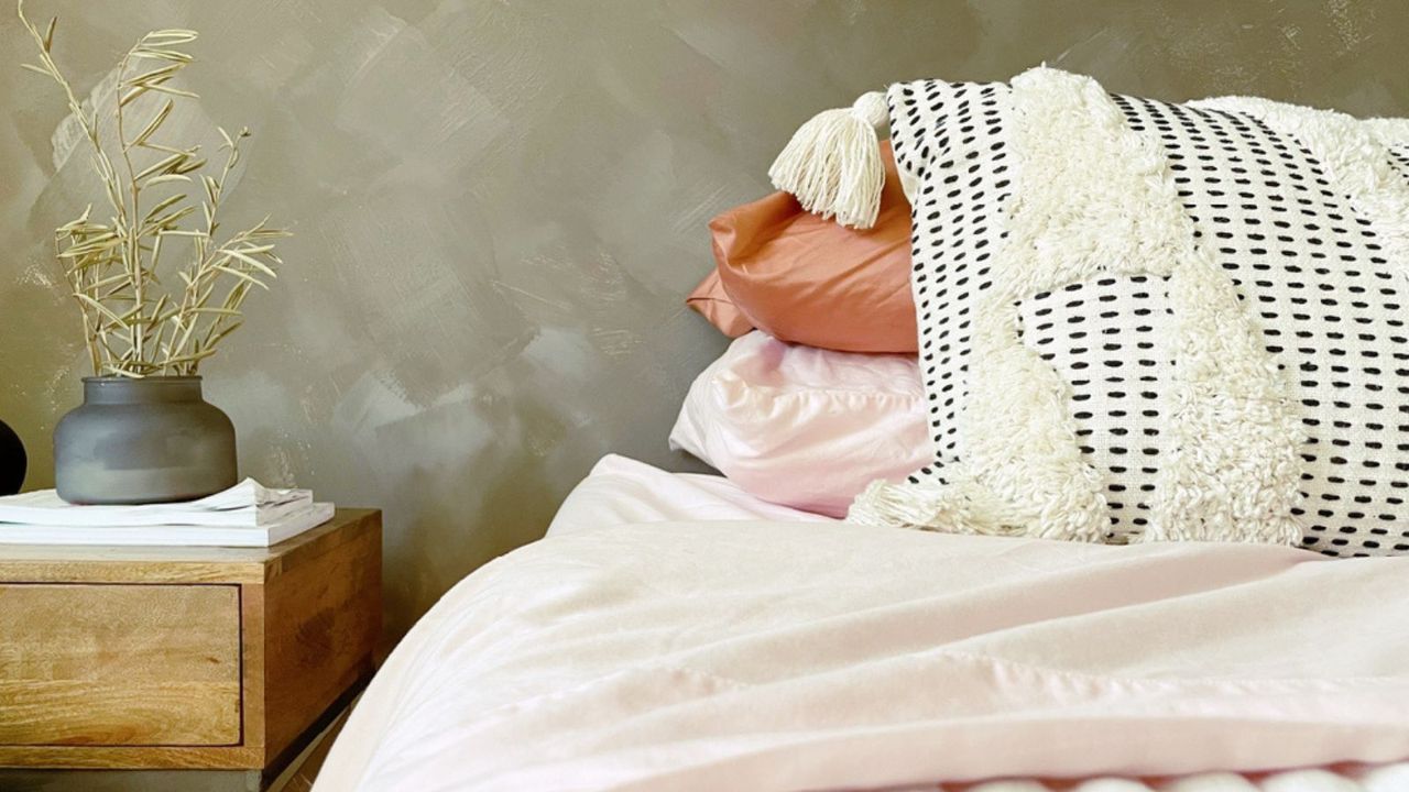 A pink toned limewashed bedroom