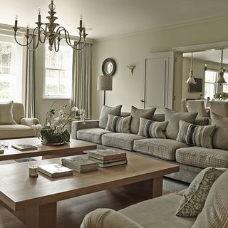 symmetrical sitting room with sofa cushions twin coffee table and rivoli six arm chandelier