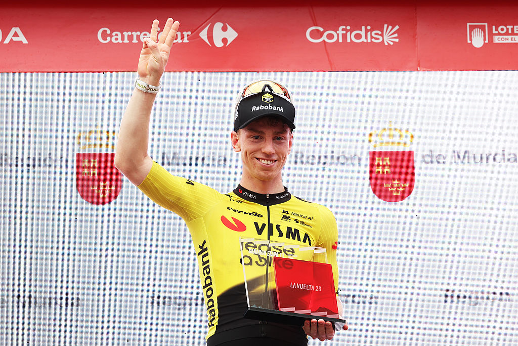 Matthew Brennan of Great Britain and Team Visma | Lease a Bike celebrates at podium as stage 11 winner