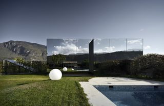 Mirror houses by Peter Pichler Architecture, reflecting the cloudy skies above