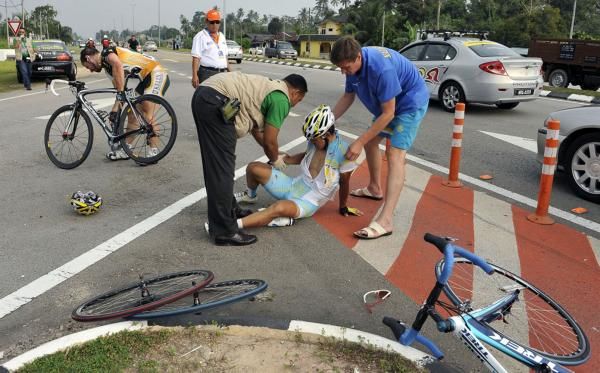 This Kazakh rider has had better days as Zach Bell (Kelly Benefits) checks his bike after a crash