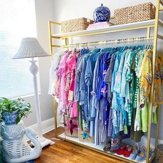 Colorful clothes hanging in open closet