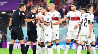 Pepe, Bruno Fernandes and several other Portugal players complain to the referee during their team's 1-0 loss to Morocco at World Cup 2022.