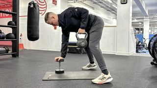 Personal trainer Ollie Thompson performing a kettlebell gorilla row