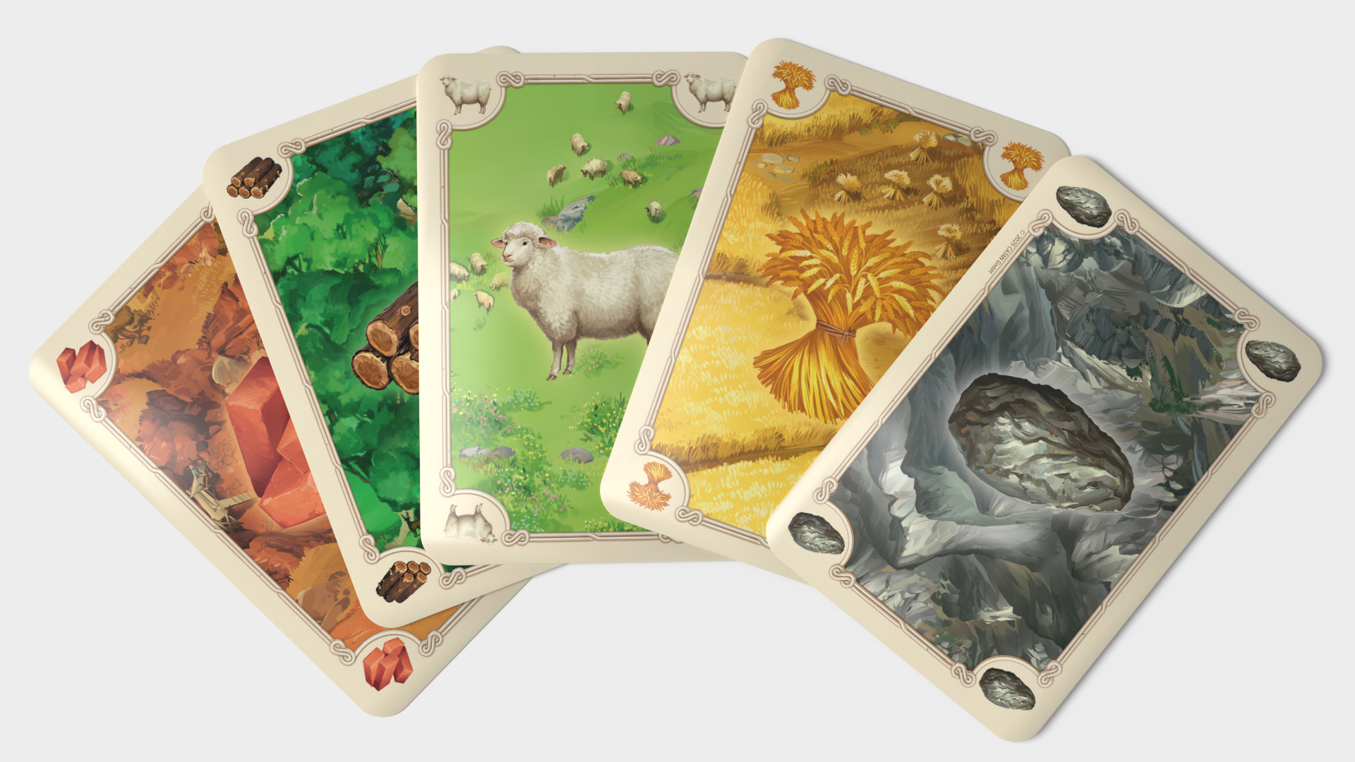 Las cartas de Catan se extienden sobre un fondo liso.