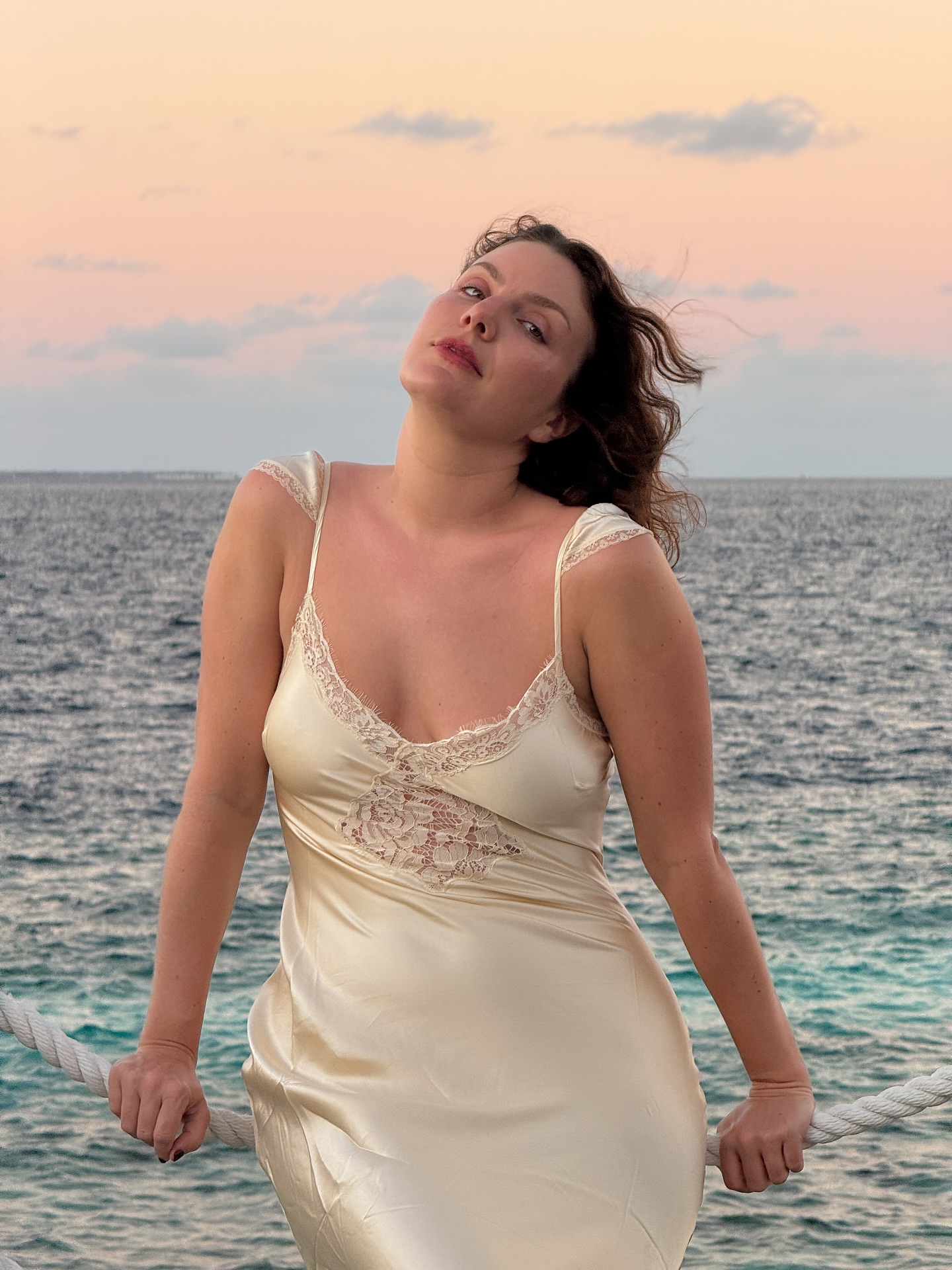 Emma Horeau with pink lips, flushed skin, and wavy hair