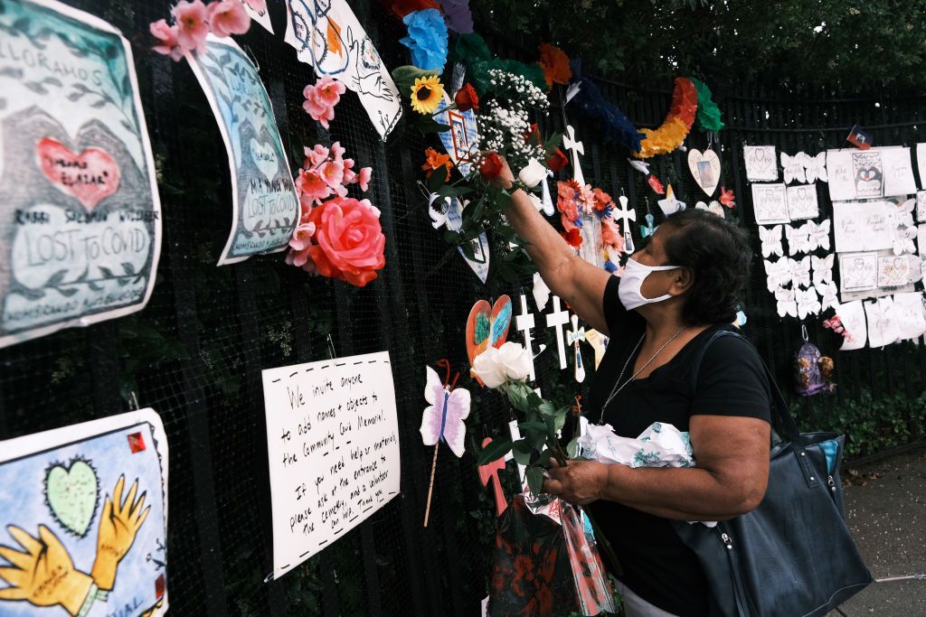 Memorials hang from the front gate of Greenwood Cemetery during an event and procession organized by Naming the Lost Memorials to remember and celebrate the lives of those killed by the Covid-19 pandemic on June 08, 2021 in New York City.