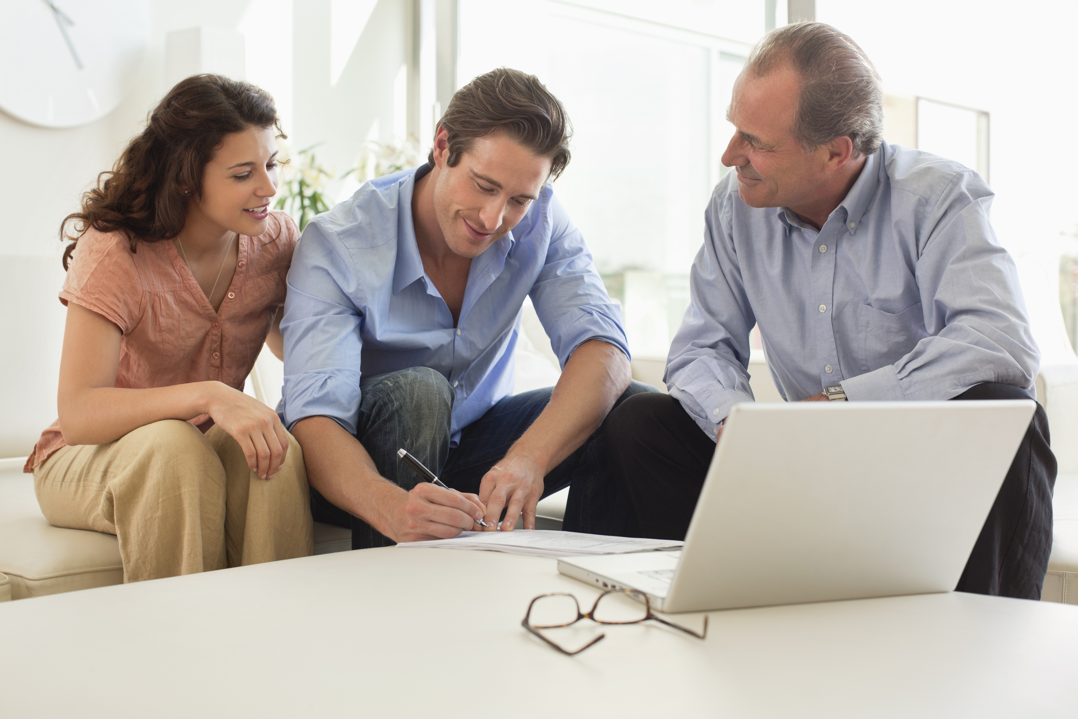Couple signing financial documents