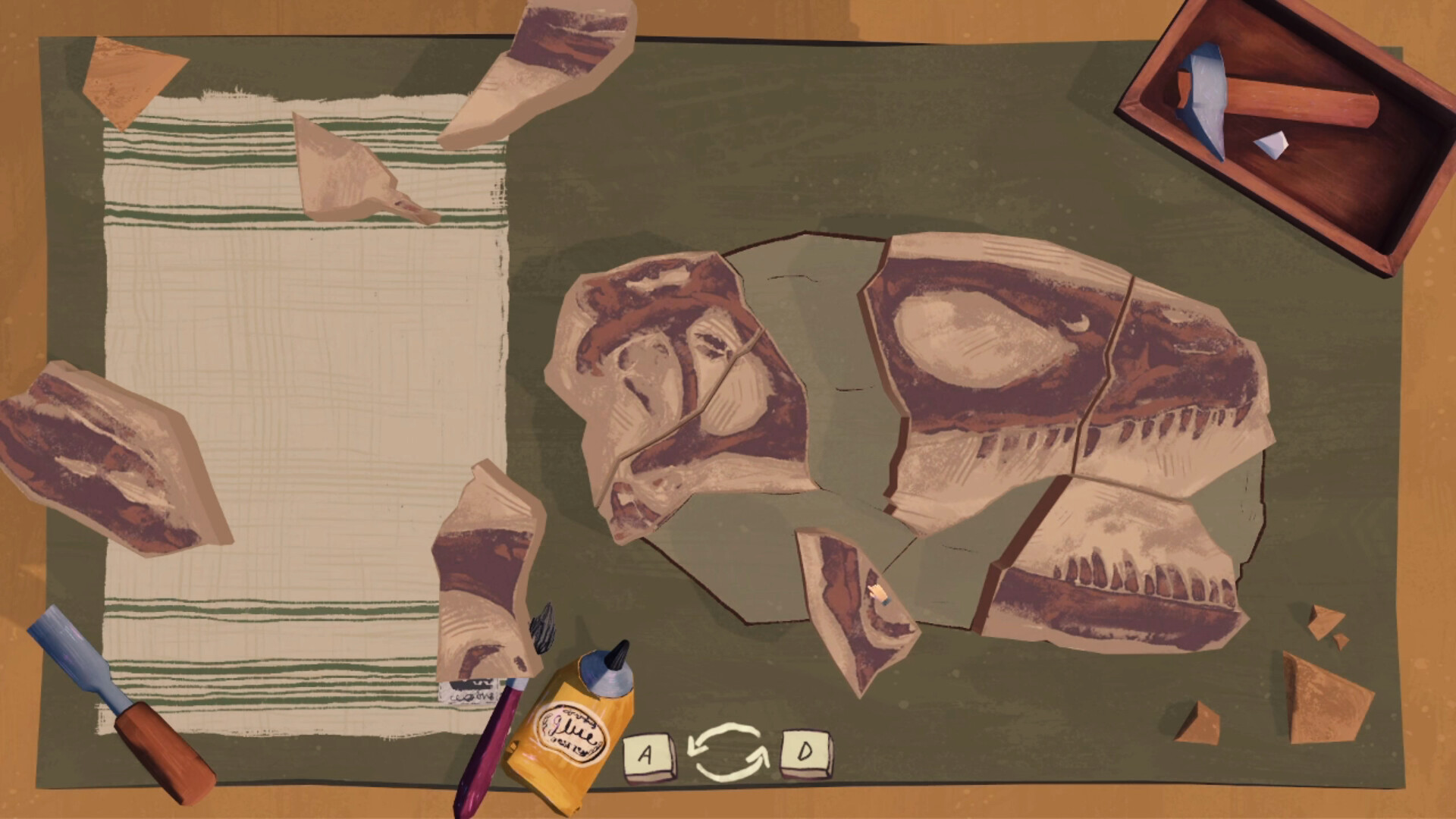 Fragments of a dinosaur fossil and brushes laid out on a table in indie management sim, Fossil Quest