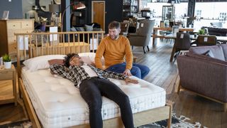 A couple go mattress shopping together in store