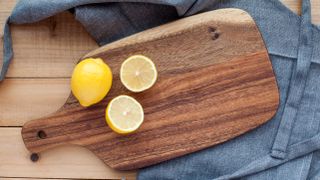 Wooden cutting board with lemon