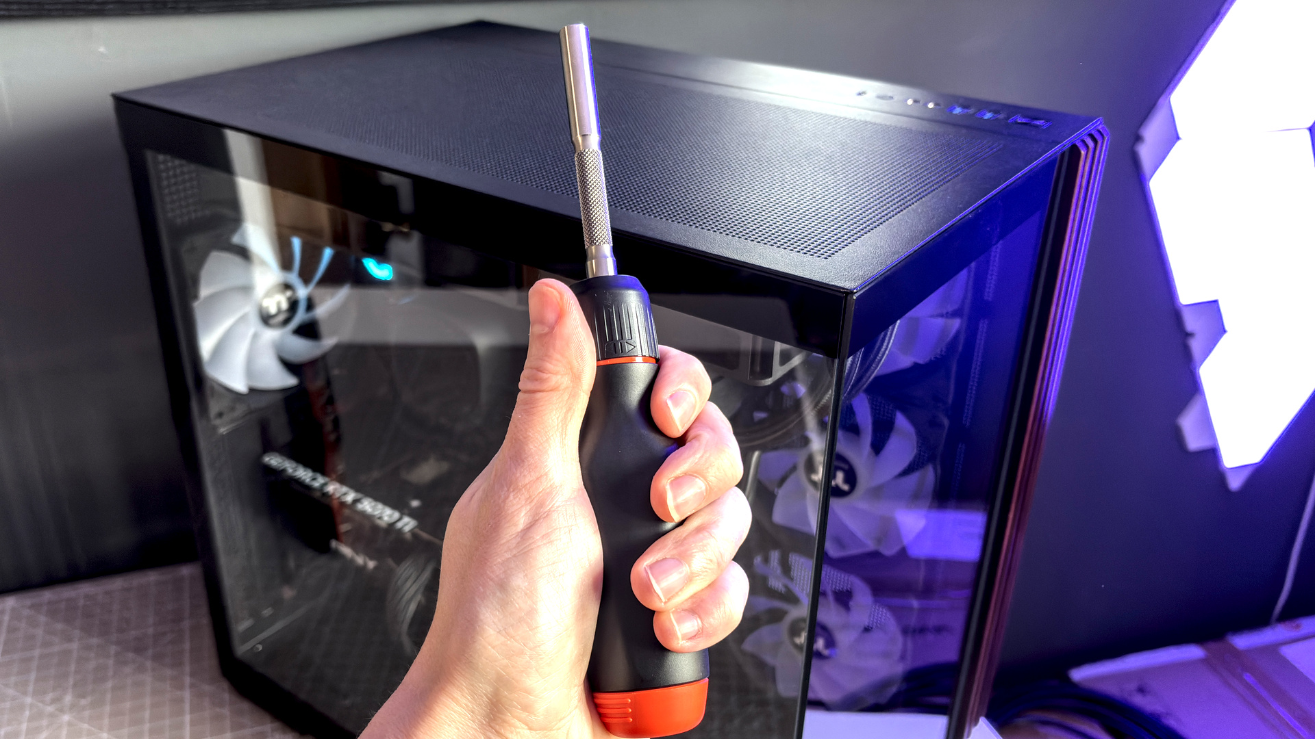 Two screwdrivers on a desk with orange highlights, sold by the YouTube channel Linus Tech Tips, or LTT for short.