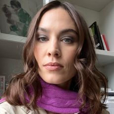 A selfie of Alexa Chung wearing a purple scarf with a dark smoky eye