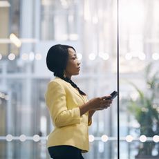 Woman On Phone In Office Looking Tired