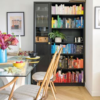 dining room with bookcase and glass dining table