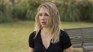 Jennifer Holland's Emilia Harcourt looking shocked in park in Peacemaker Season 2