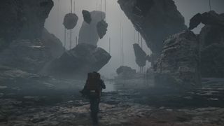 Sam Bridges navigates a goopy area of warped rocks in Death Stranding 2: On The Beach