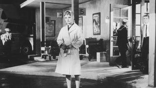 Audrey Hepburn wearing a trench coat
