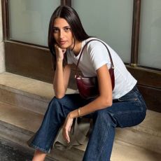 @salome.mory wears cropped flare jeans with a t-shirt and thong sandals