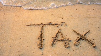 tax written in sand on beach for low sales tax rates