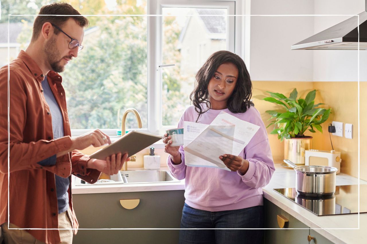 Couple talking about bills in kitchen at home