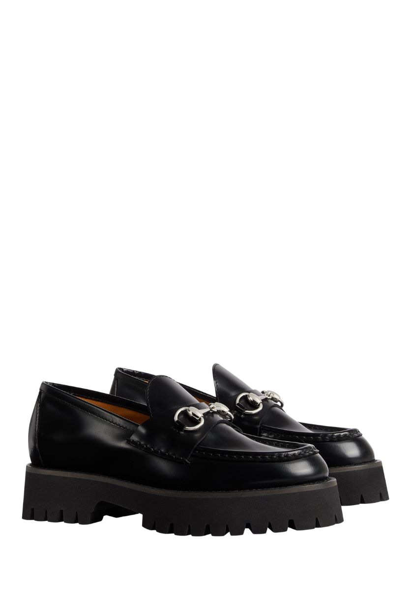 A pair of lug sole Gucci loafers with a horsebit detail. 